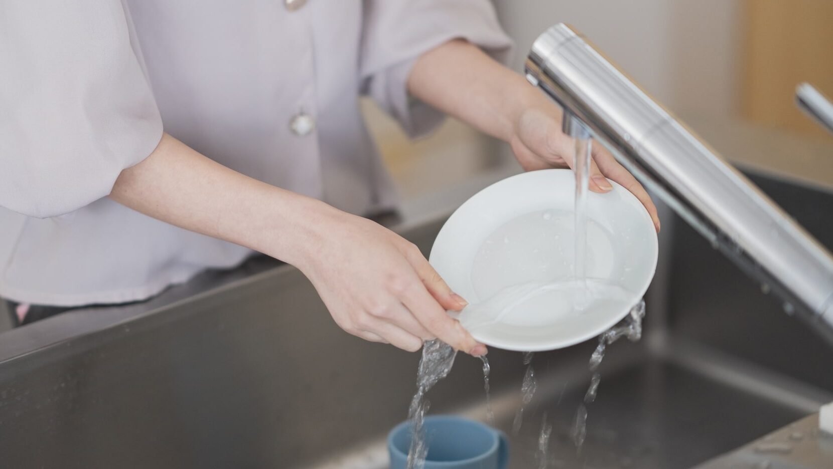皿を洗う女性